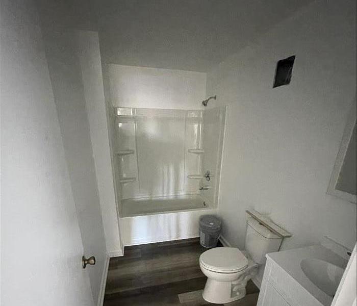 Image shows the same bathroom directly after repairs