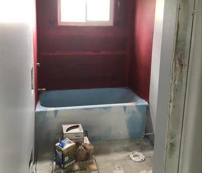 This image shows a bathroom in the middle of repair after a house fire.
