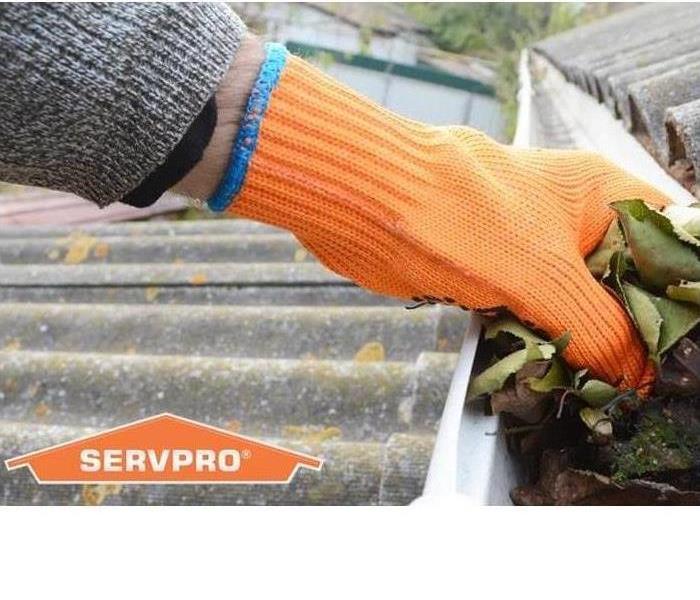 SERVPRO representative cleaning rain gutters.